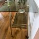 Vintage brass and smoked glass dessert trolley on wheels.