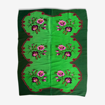 Charming vintage floral carpet on a green background handwoven in Romania, colorful flowers