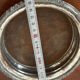 Antique silver-plated bottle coaster with floral decoration.