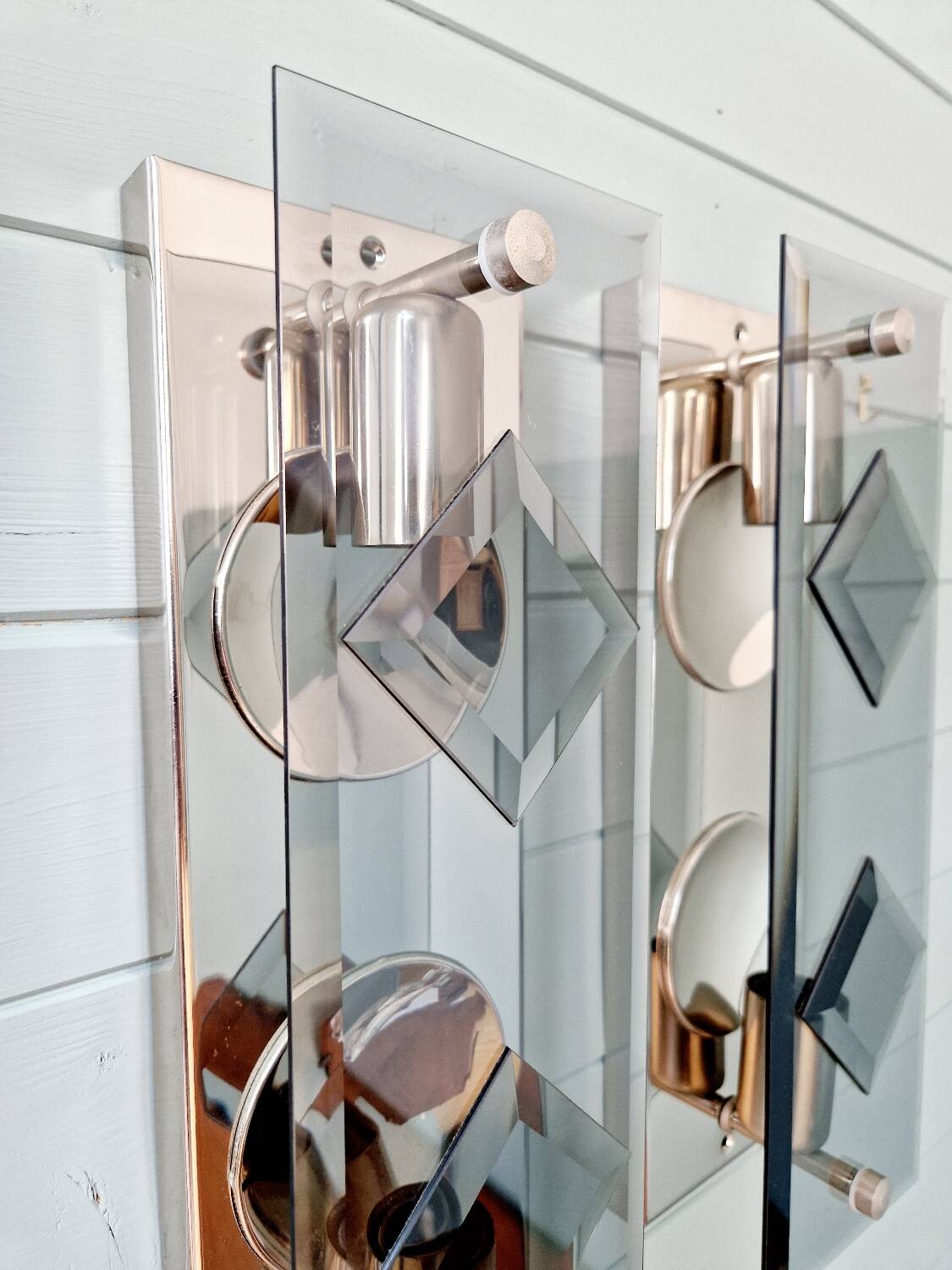 Pair of chrome metal and smoked glass wall sconces, 1970s.