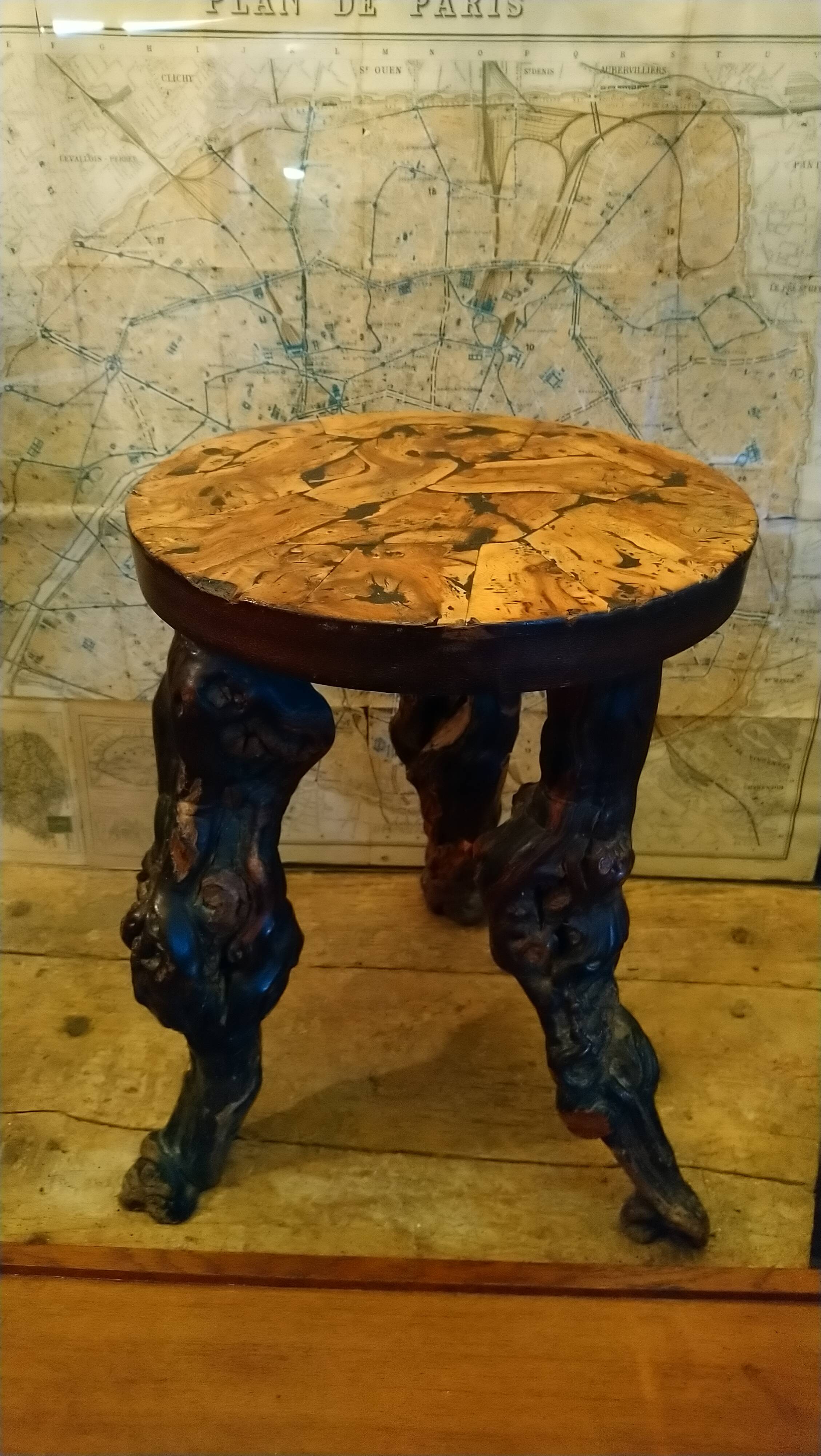 Brutalist tripod stool made from vine stumps.