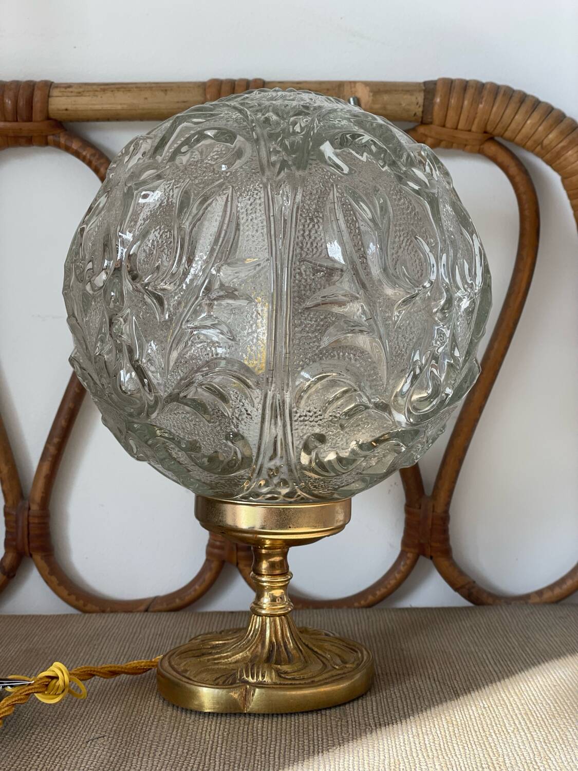 Textured round globe table lamp with a gold brass base