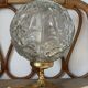 Textured round globe table lamp with a gold brass base