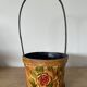 Metal basket with rose patterns