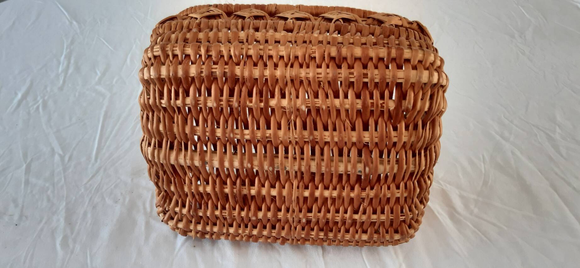 Old wicker basket with diamond-shaped decorations
