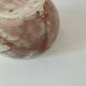 Red-orange glazed ceramic workshop bowl with floral decoration.
