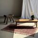 Brown Indonesian teak coffee table, with a border and cylindrical legs H40 L103.