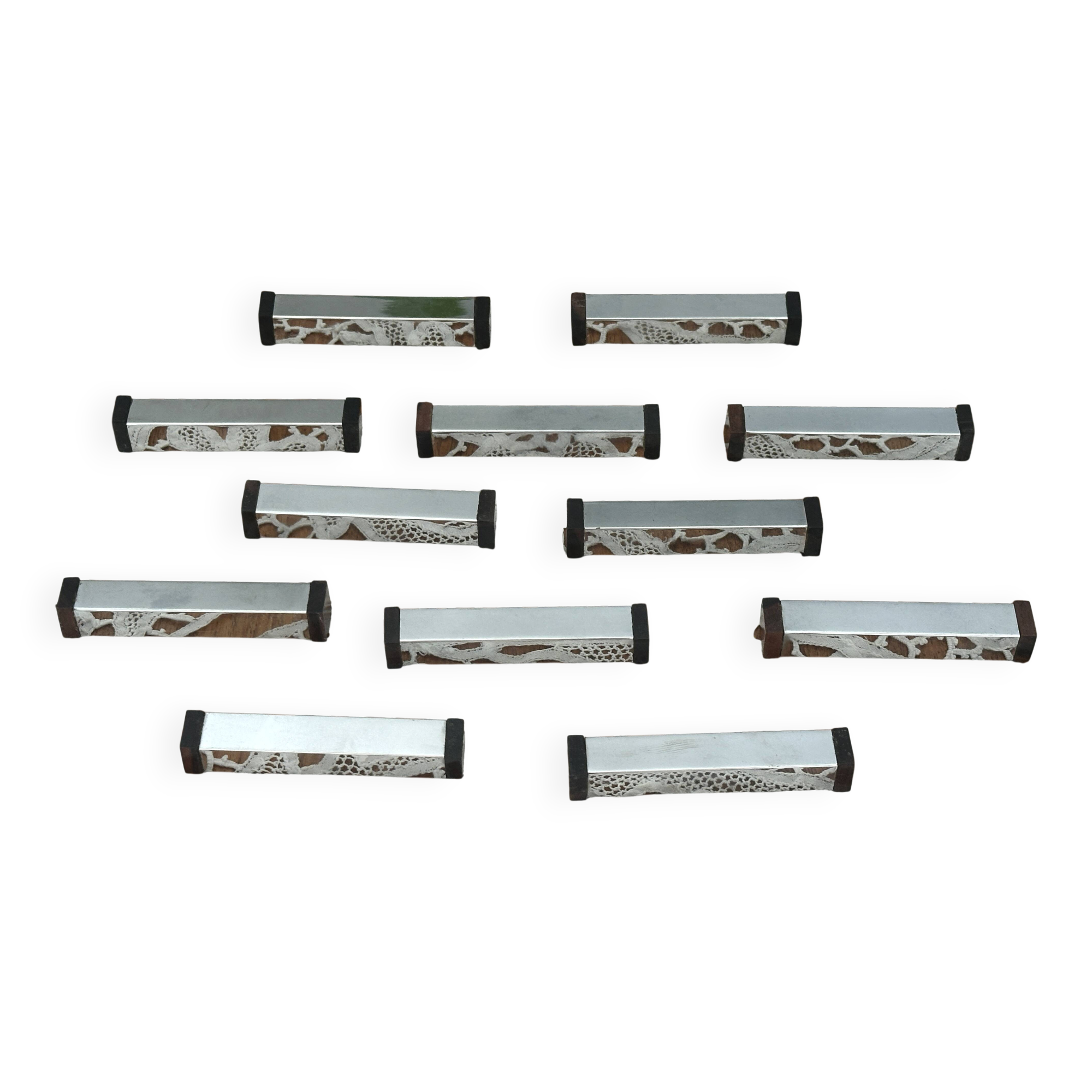 Set of 12 Art Deco Modernist knife rests in chrome metal and blackened wood.