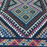 Blue carpet with multicolored patterns woven hands in natural wool
