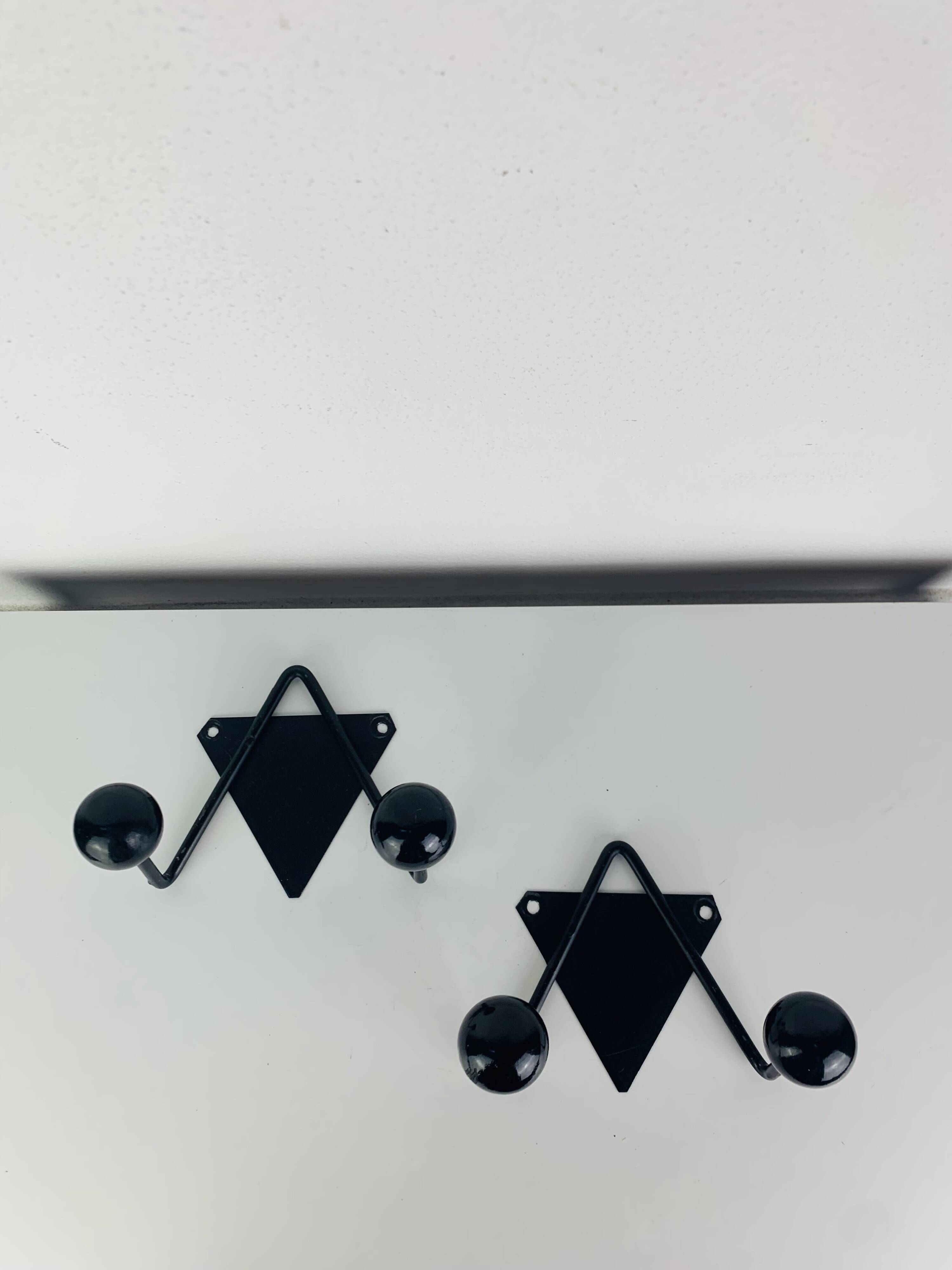 Pair of wall hooks from the 1950s, black metal