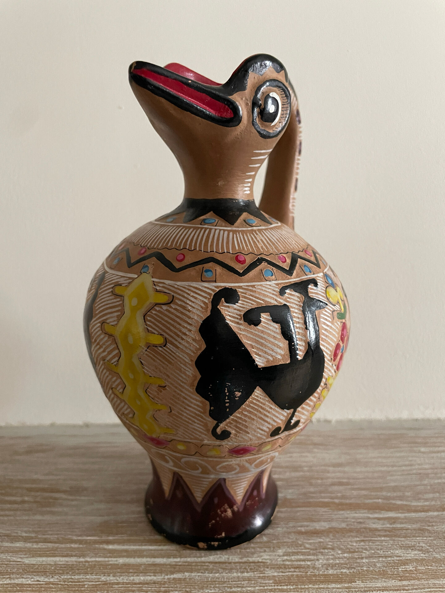 Clay pitcher with a bird head