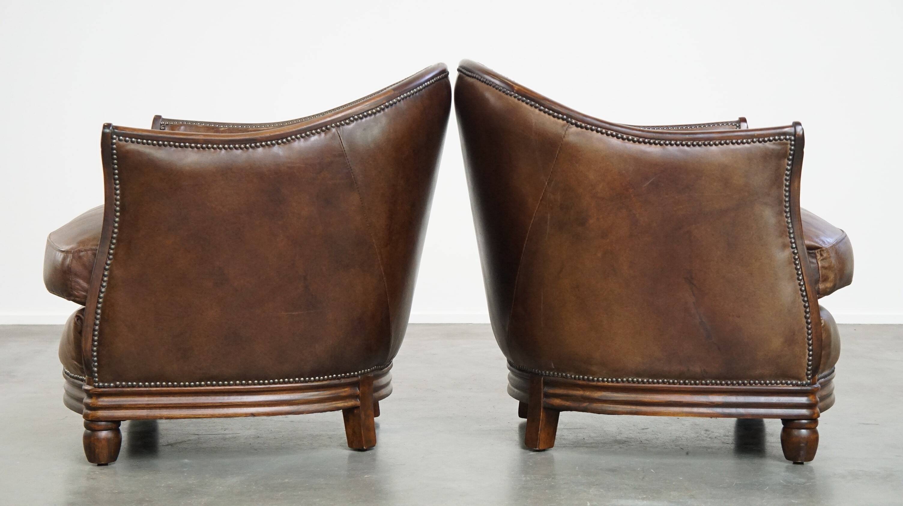 Set of 2 club chairs/armchairs in dark cognac leather
