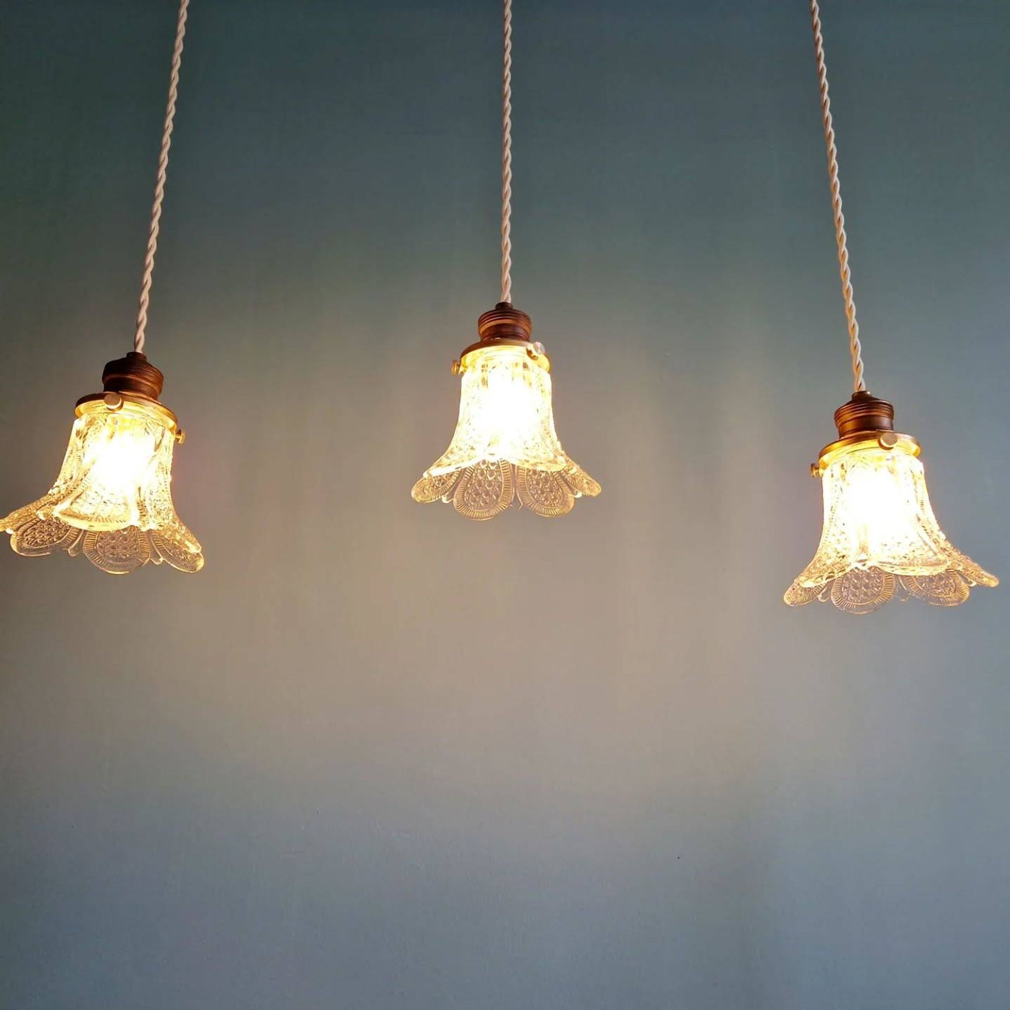 Art Deco trio of pendant lights/table lamps in clear glass, 1920s-30s.