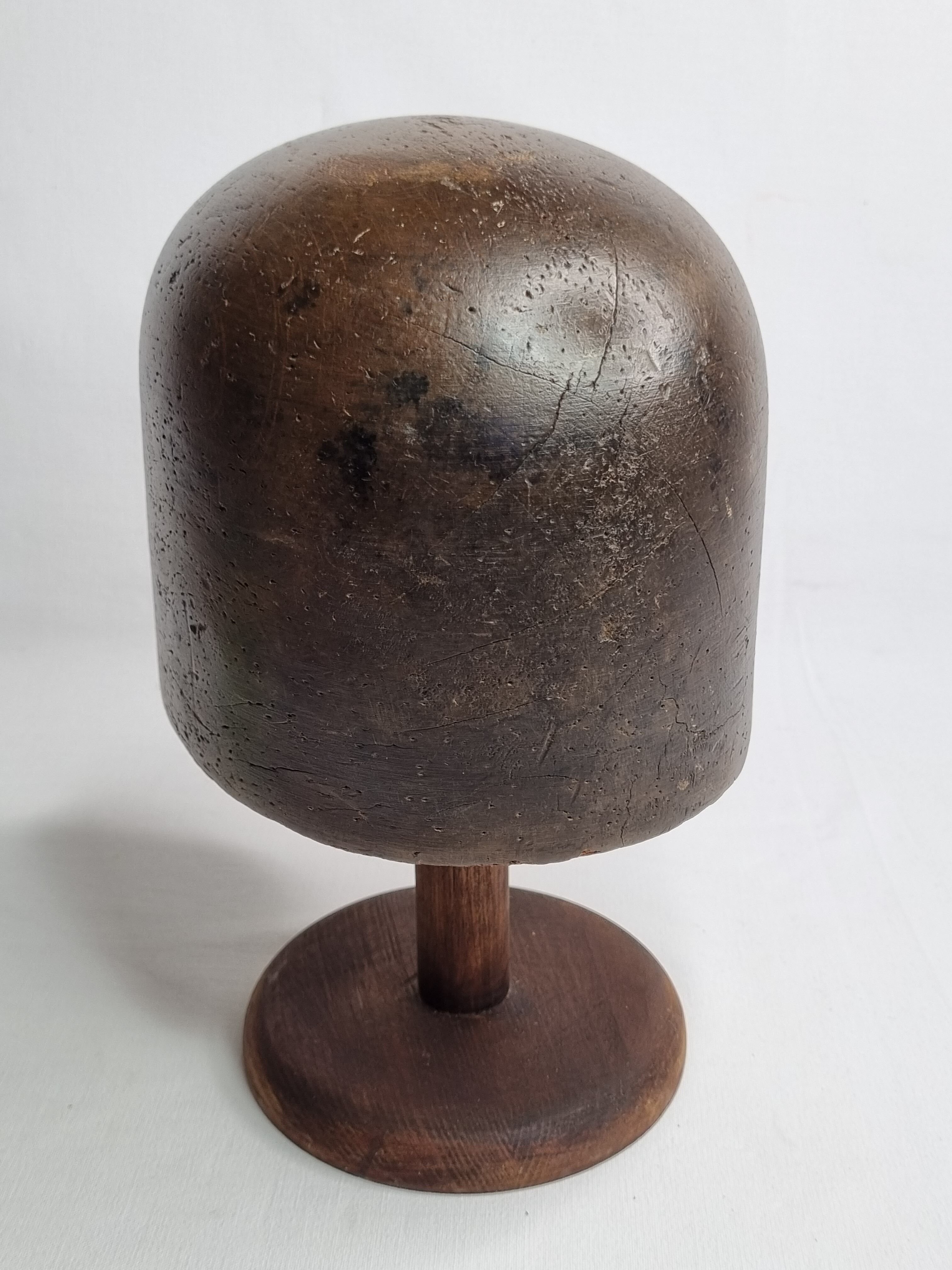 Old solid wood hat shape on foot, 1900