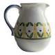 Large white terracotta carafe with a stylized green and yellow frieze pattern