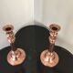 Pair of pink copper candlesticks