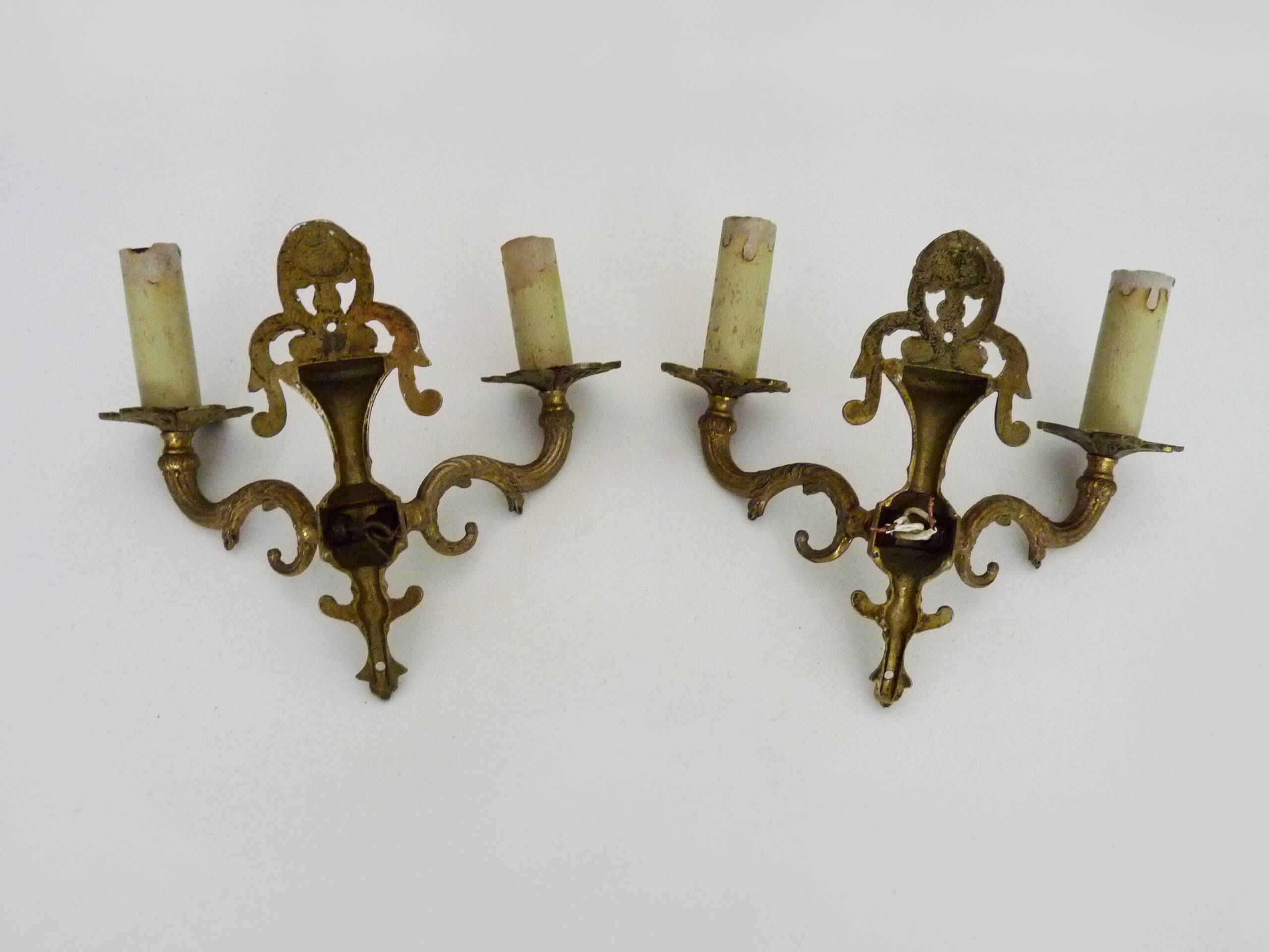 Pair of two-armed fire pot wall lights in gilded bronze.