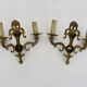 Pair of two-armed fire pot wall lights in gilded bronze.