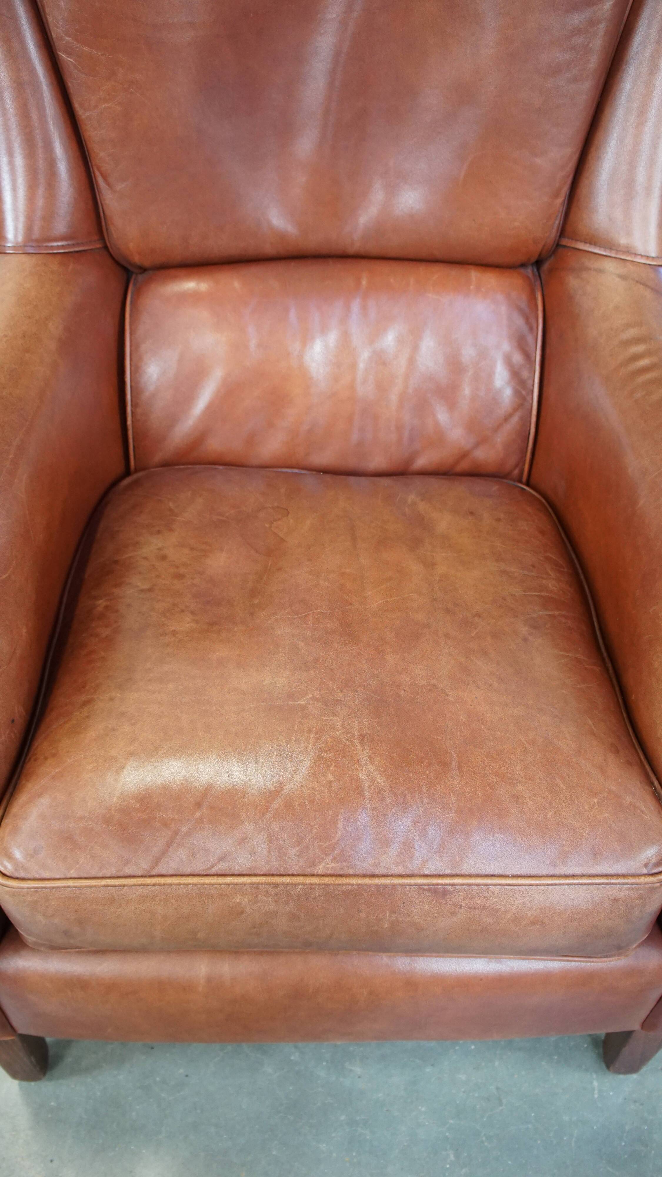 Cowhide armchair in good condition, finished with decorative nails