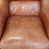 Cowhide armchair in good condition, finished with decorative nails