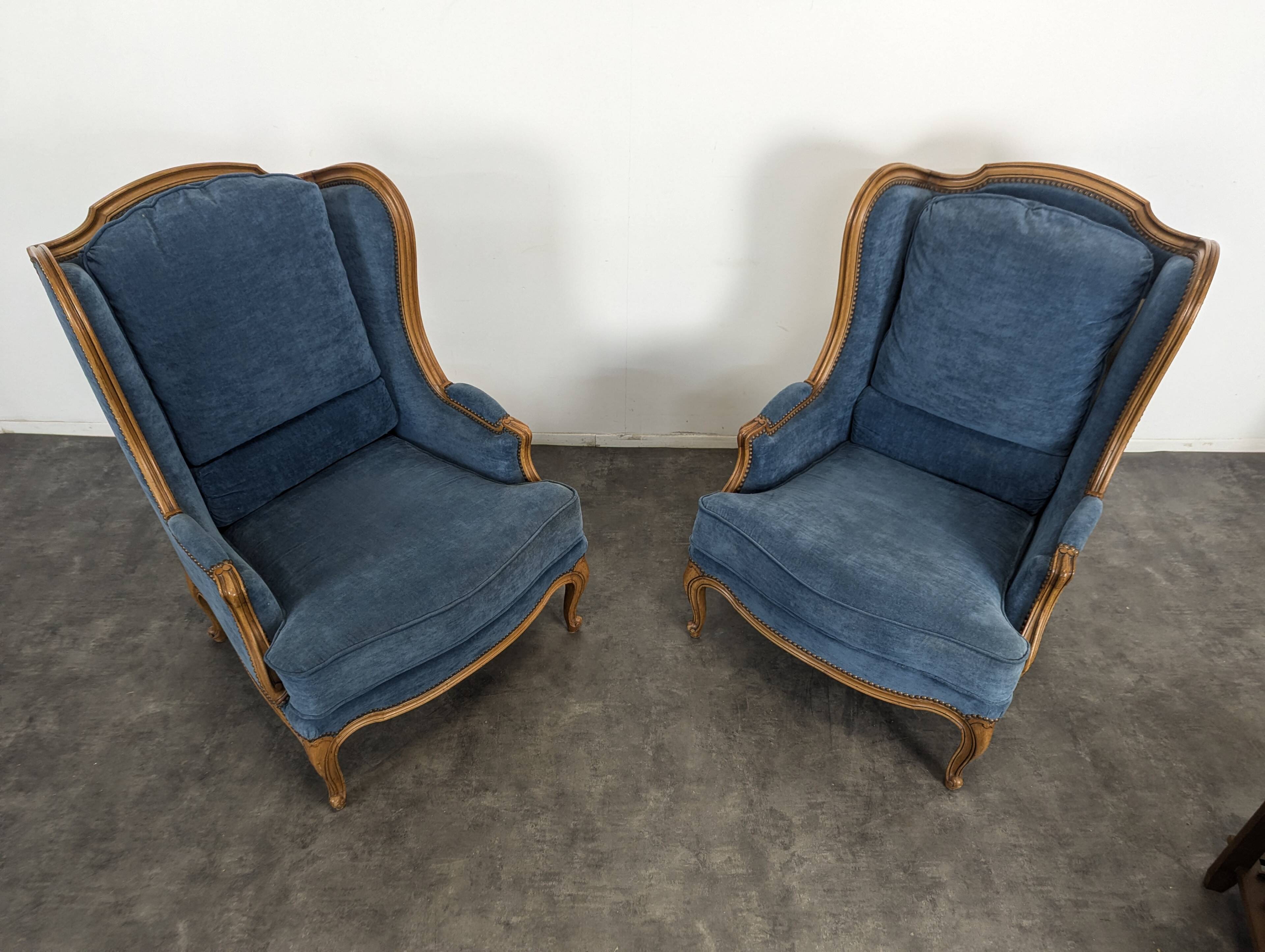 Pair of Louis XV style wingback armchairs in blue velvet.