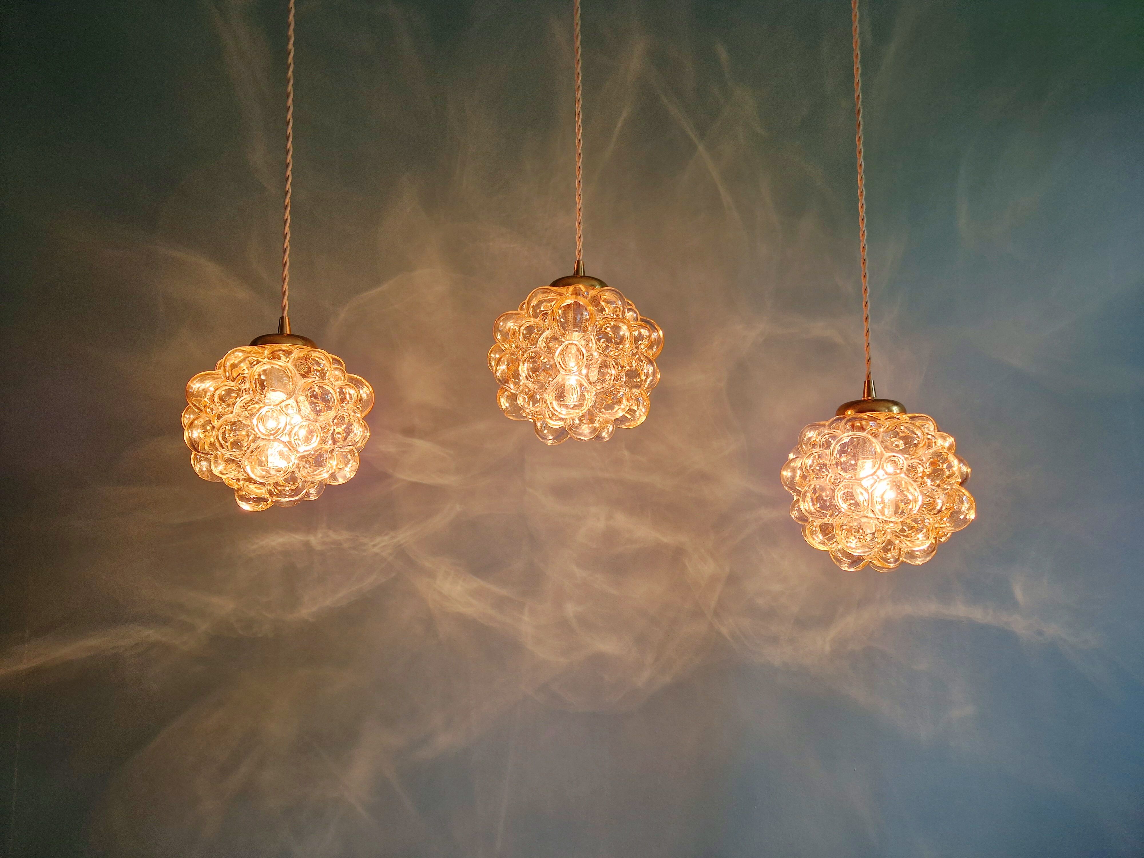 Amber bubble glass pendant (3 available), design by Helena Tynell, 1970.