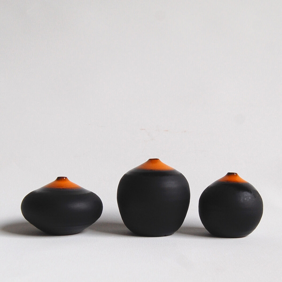 Trio of miniature black and orange ceramics Antonio Lampecco