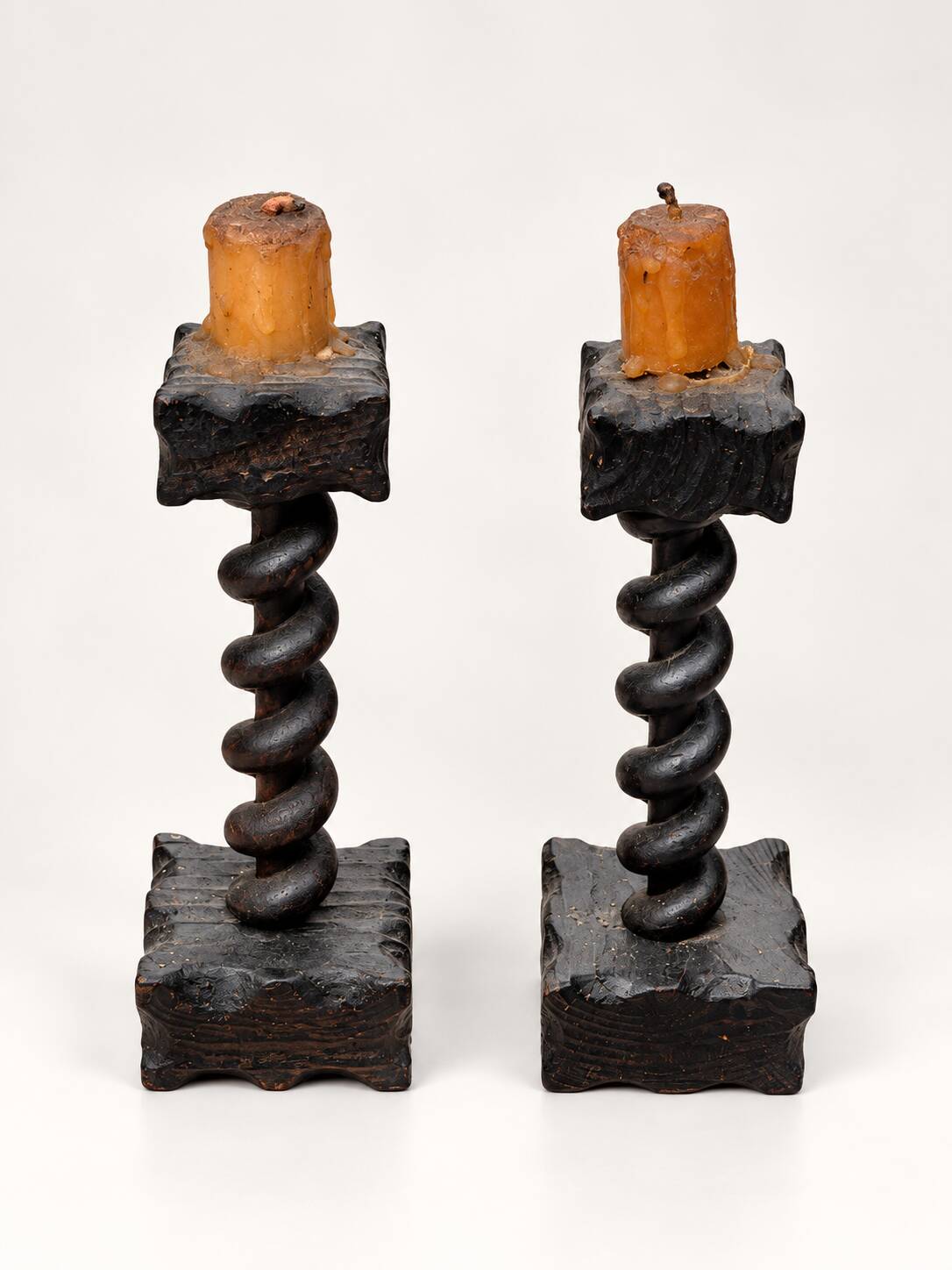 Charming pair of antique turned wooden candlesticks, featuring a beautiful p