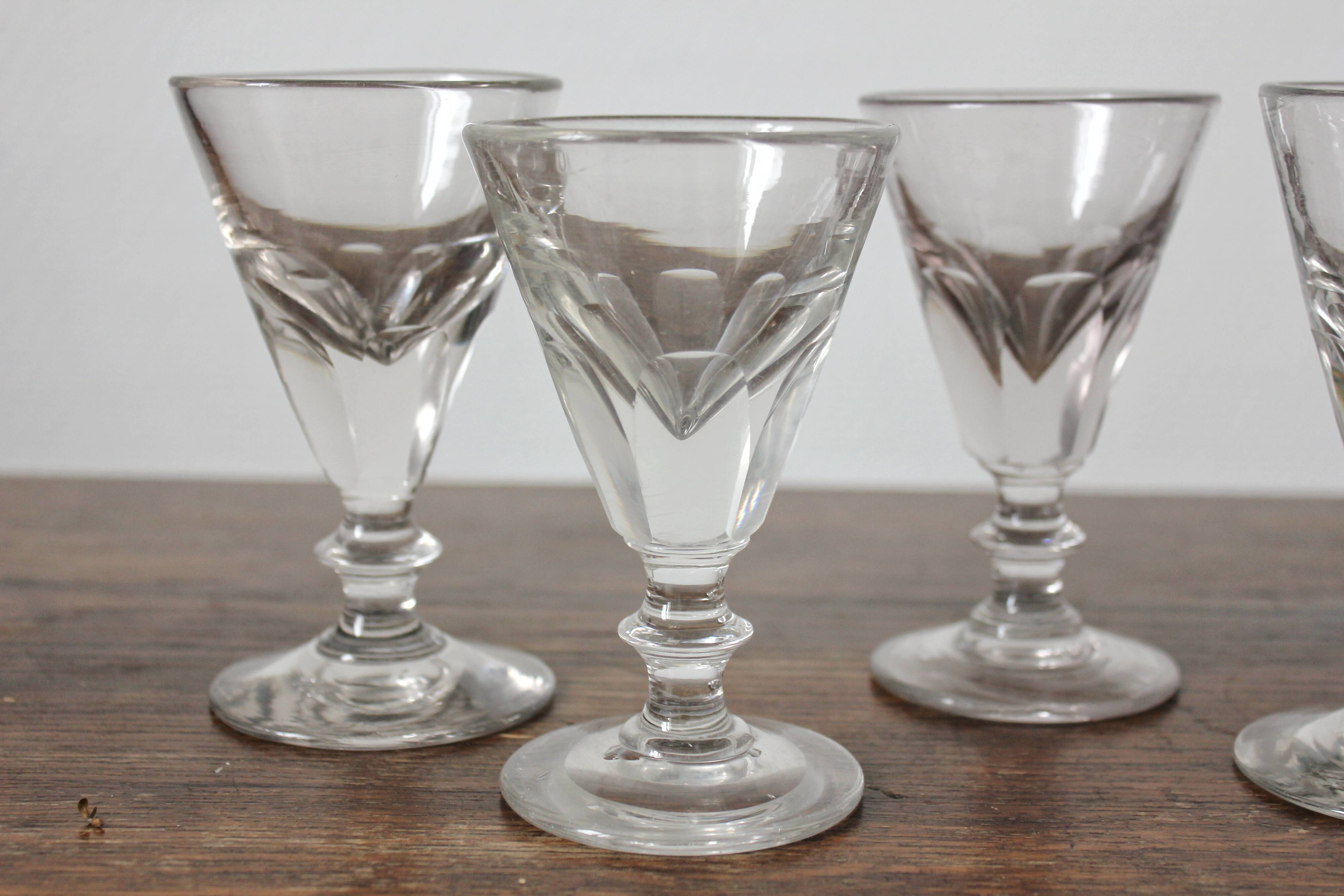 4 antique stemmed wine glasses with flat sides, made of blown glass from the 19th century