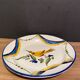 Large earthenware dish signed with bird decoration