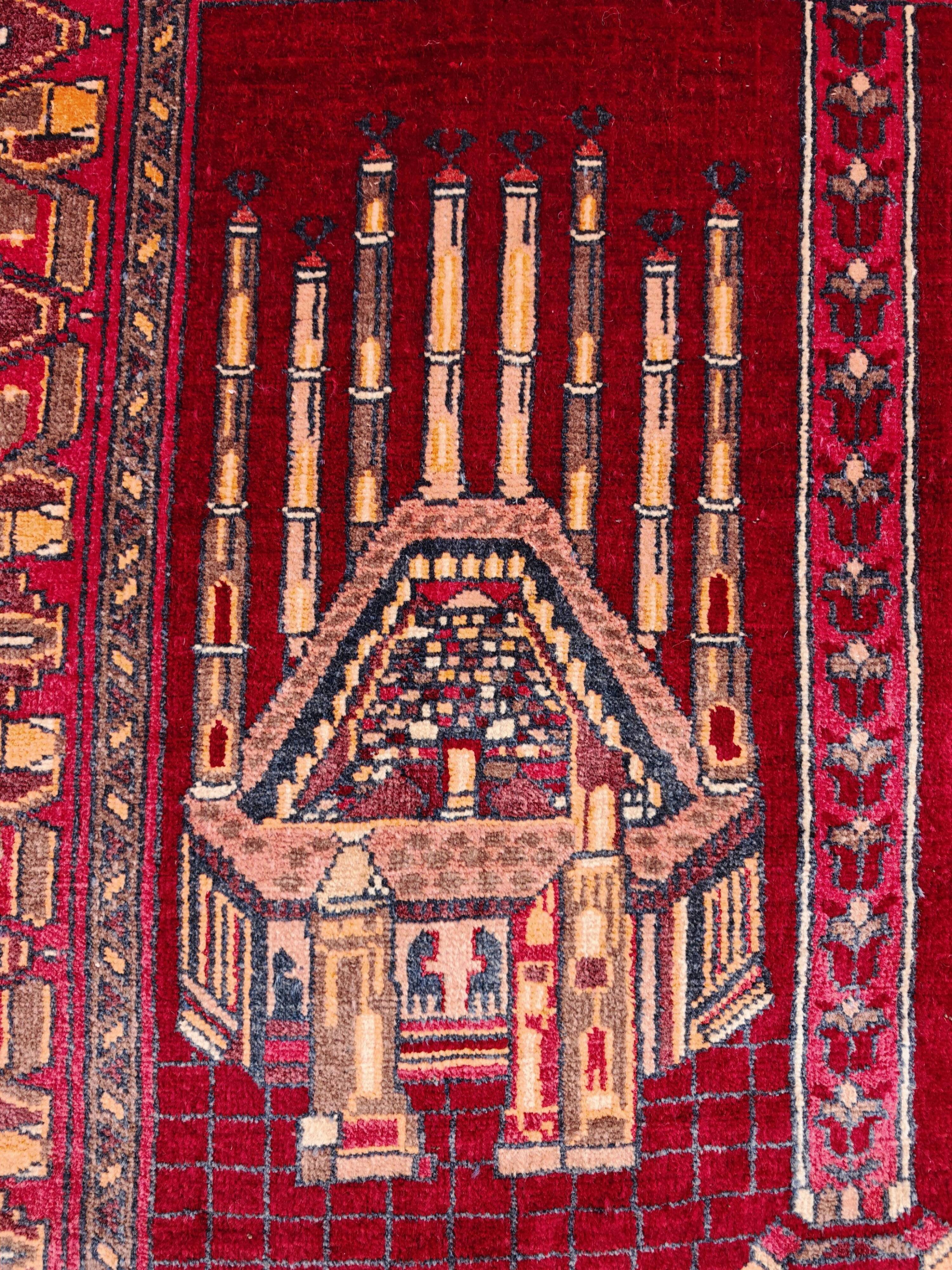 Vintage Afghan hand-knotted prayer rug with Islamic patterns.