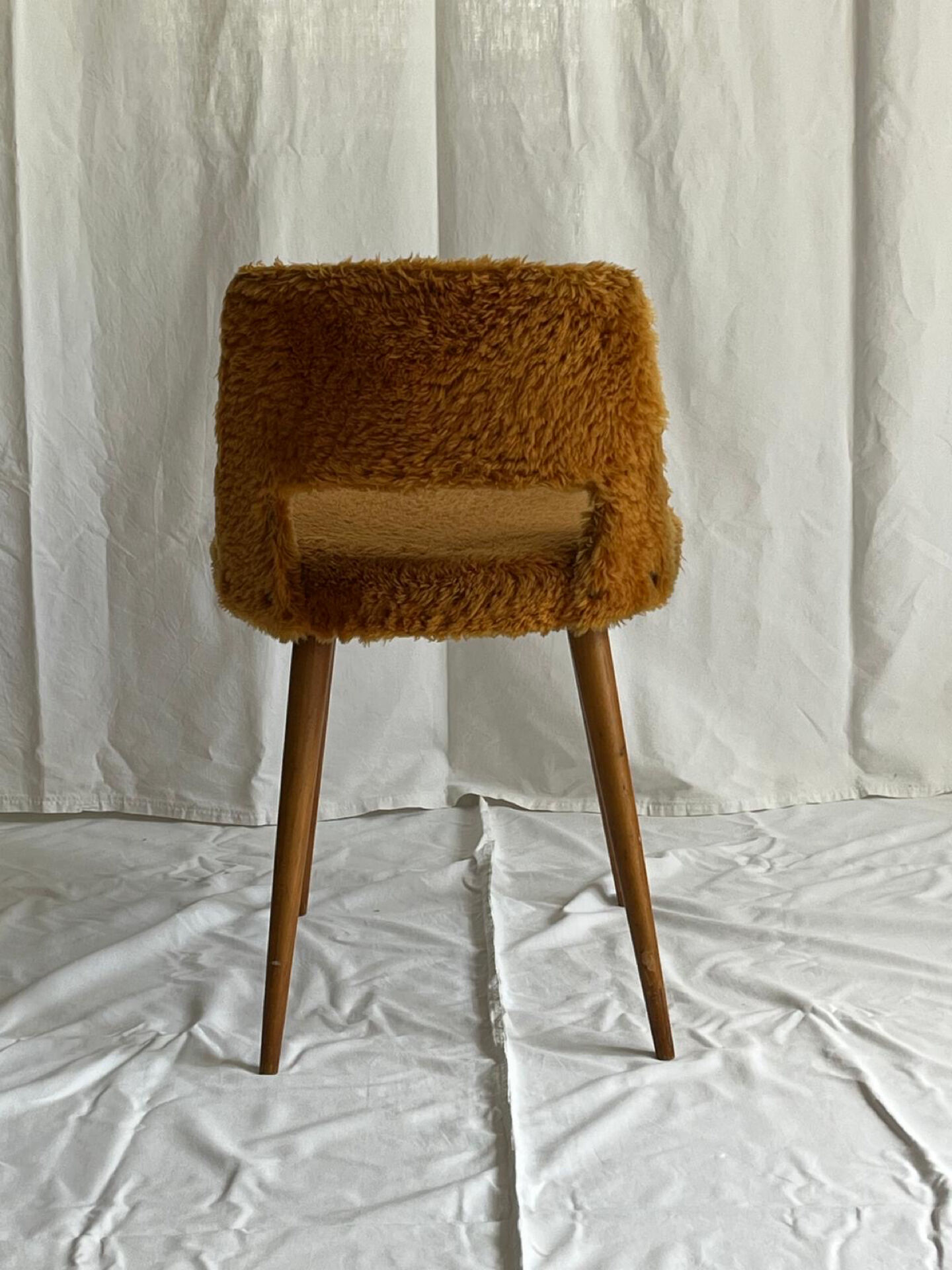 Camel barrel chair with faux fur by Baumann