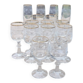 Set of 15 engraved crystal glasses with a gold rim.