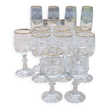 Set of 15 engraved crystal glasses with a gold rim.