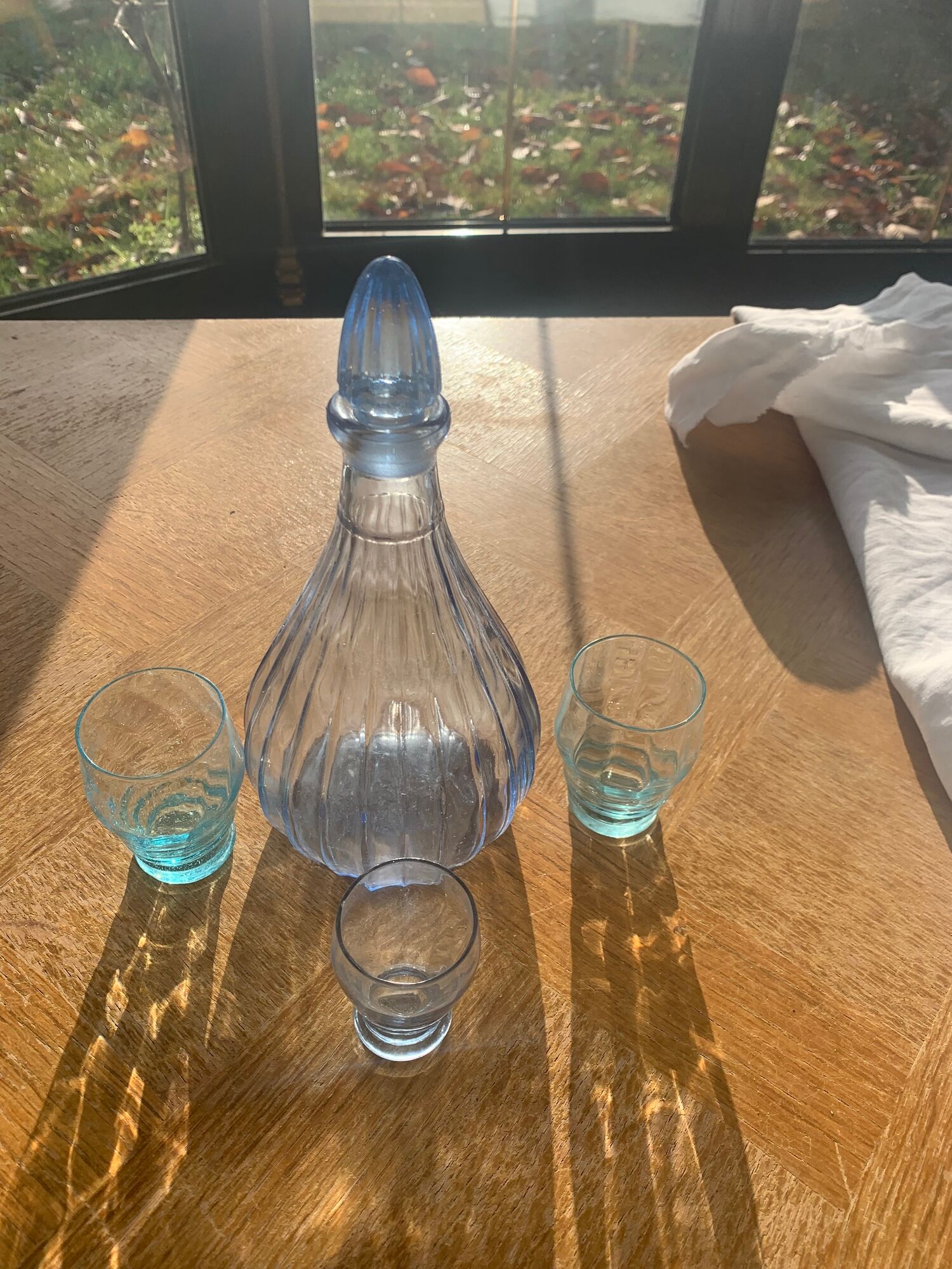 Liquor service consisting of a blue glass decanter and. 3 small antique glasses