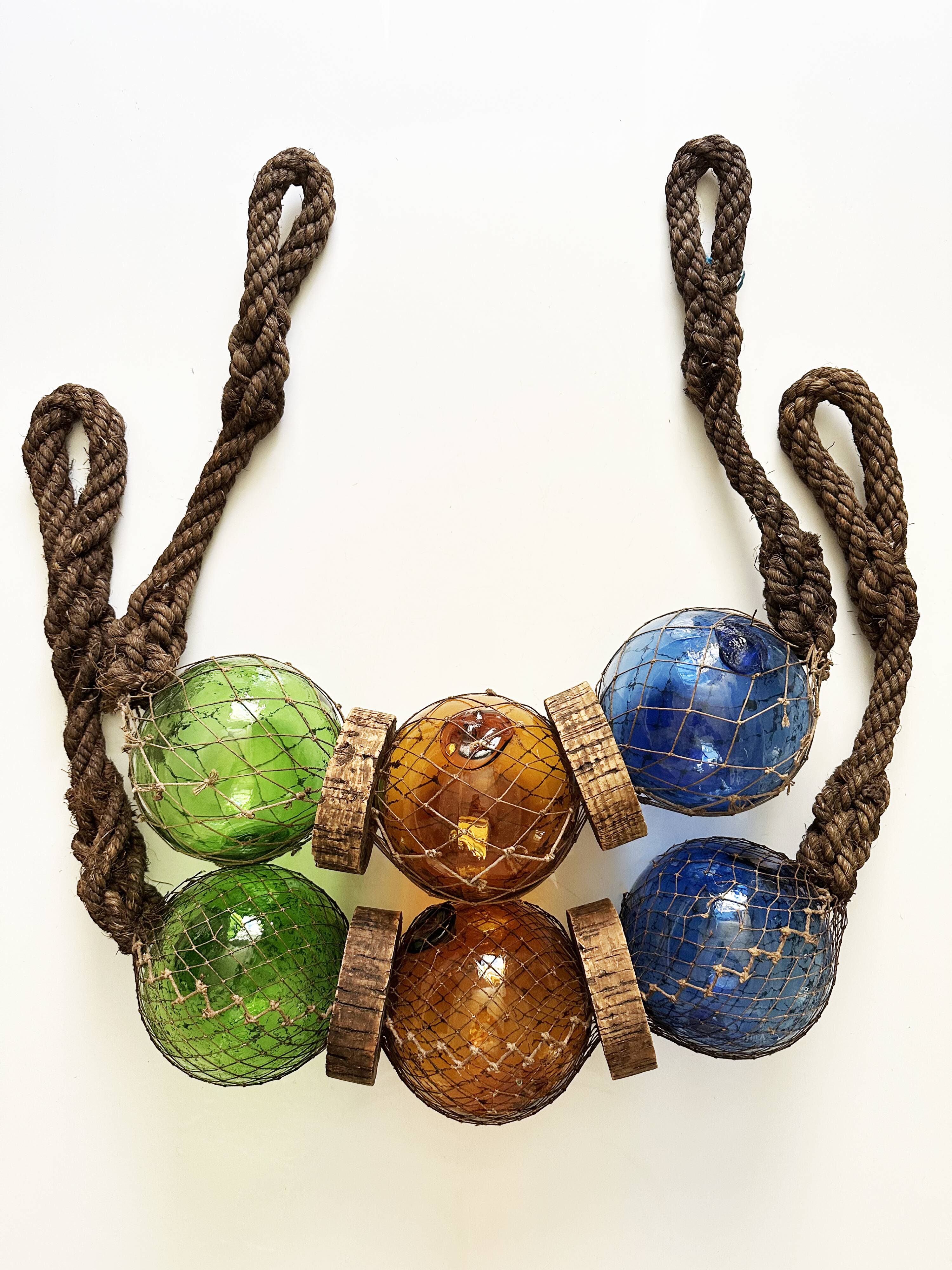 Fishing floats made of blown glass, cork, and rope. France, 1960s.