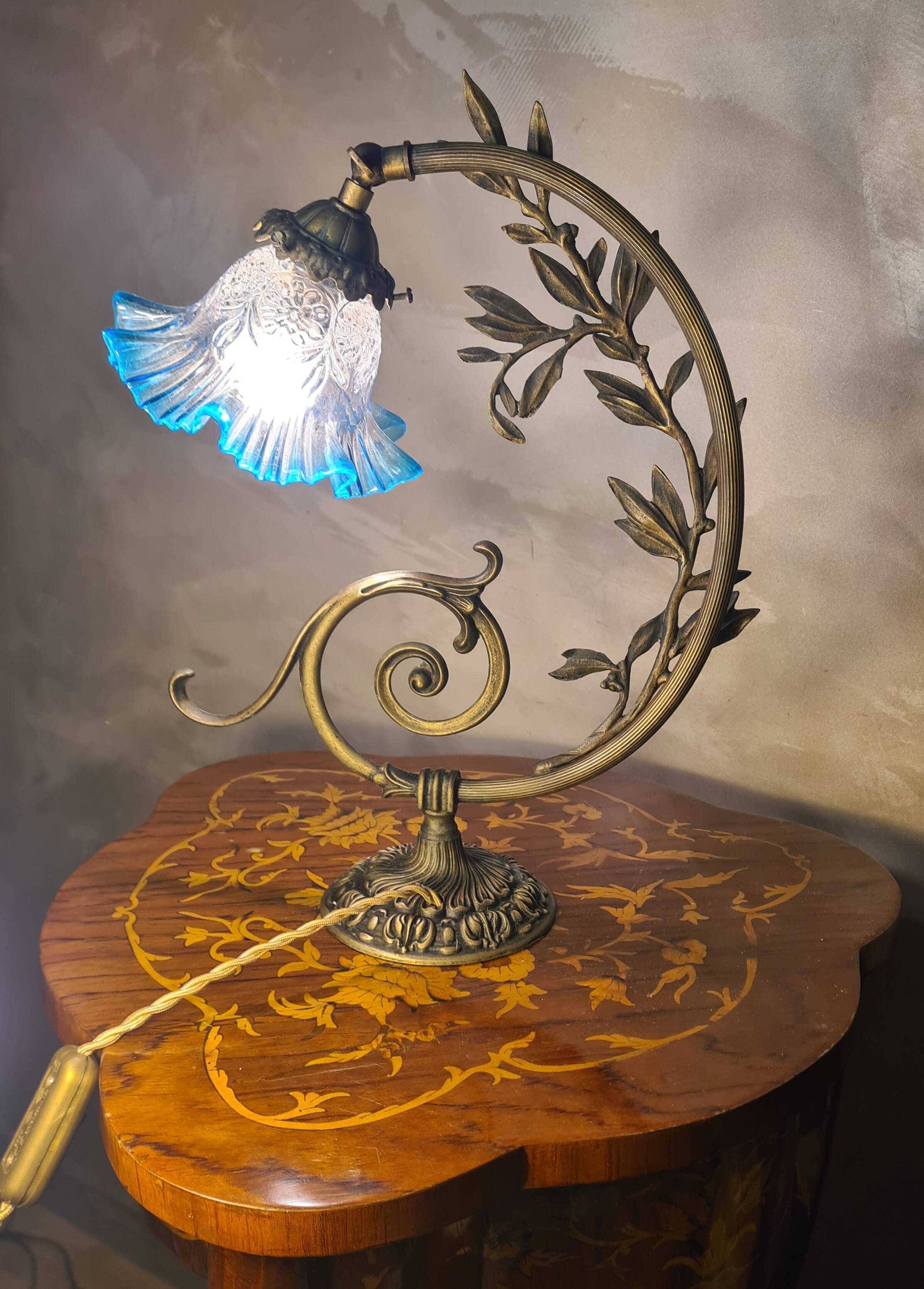 Bronze and brass lamp, transparent and blue glass shade.