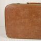 Cardboard and brown leather case