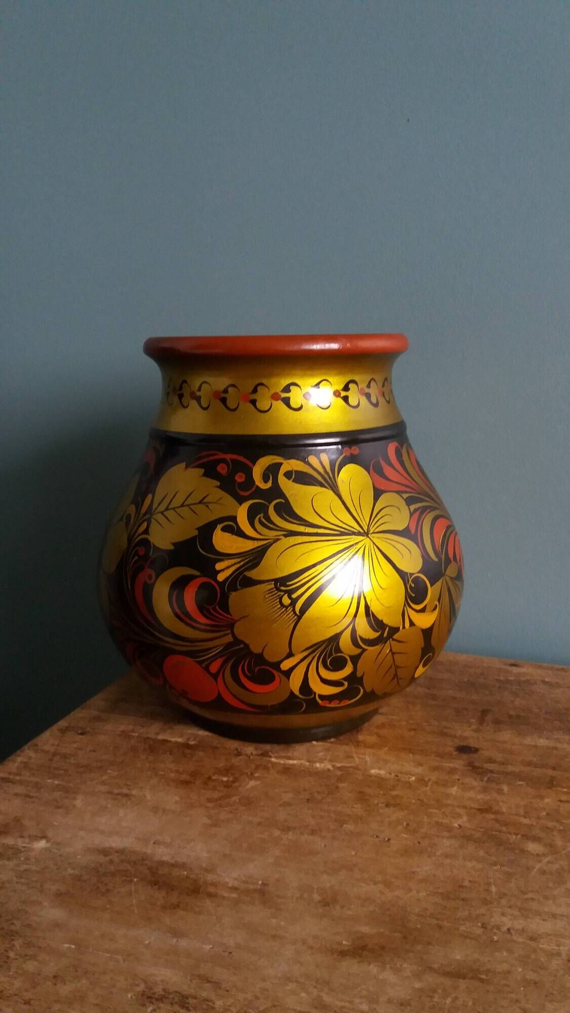 Khokhloma vase, Russian lacquered wood craftsmanship, hand-painted floral decoration.