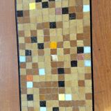 Coffee table with decorative tile.