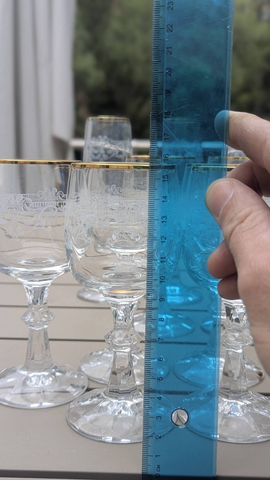 Set of 15 engraved crystal glasses with a gold rim.