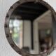 Brutalist round mirror with wrought iron and studs.