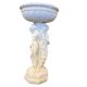 Vintage white concrete garden statue adorned with planter.