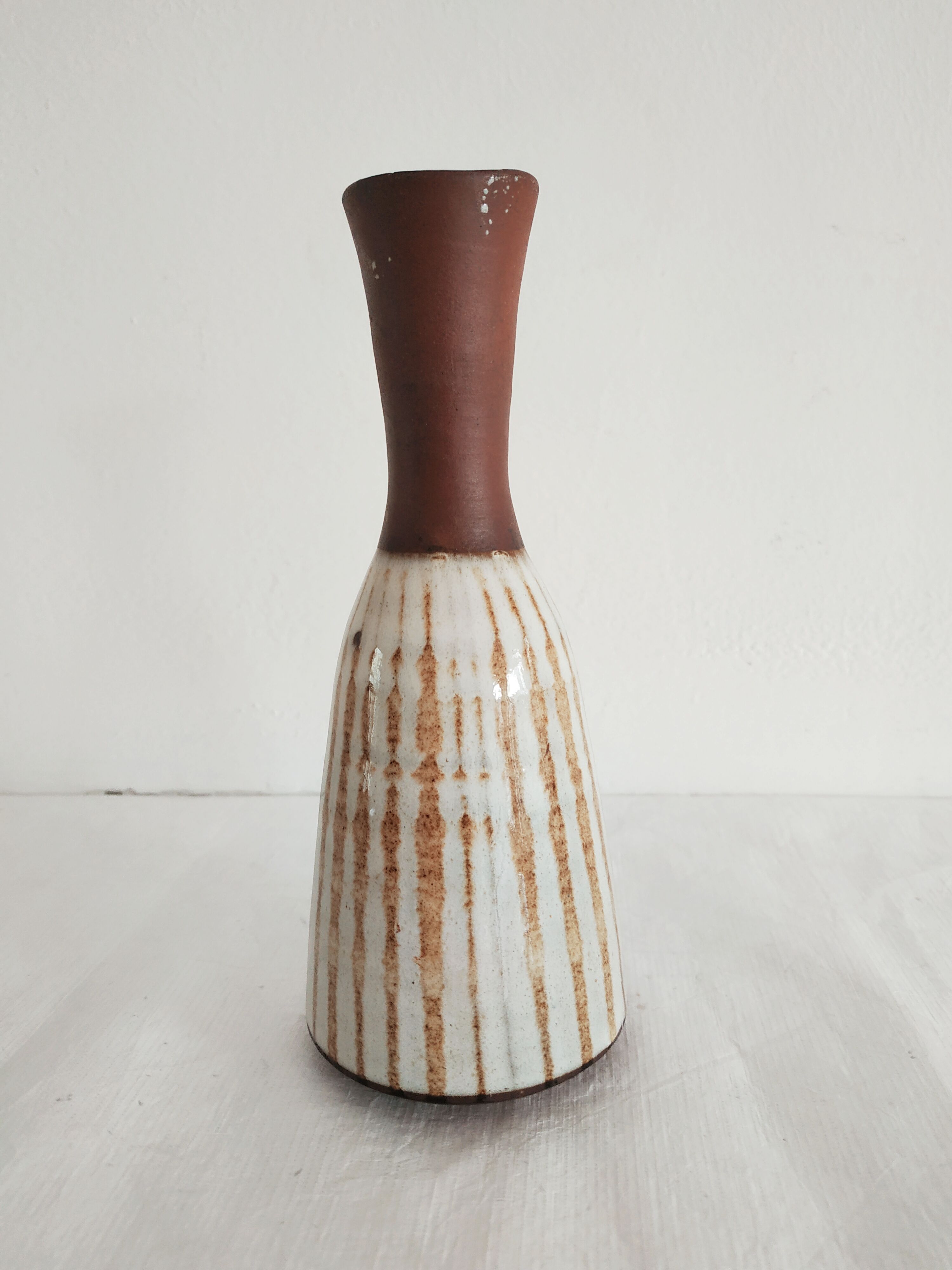 Small brown vintage vase with white enamels