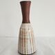Small brown vintage vase with white enamels