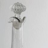 Twisted blown glass carafe with stopper, elegant design.