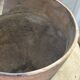 Very large light grey terracotta pot with handles and rattan crossbars.
