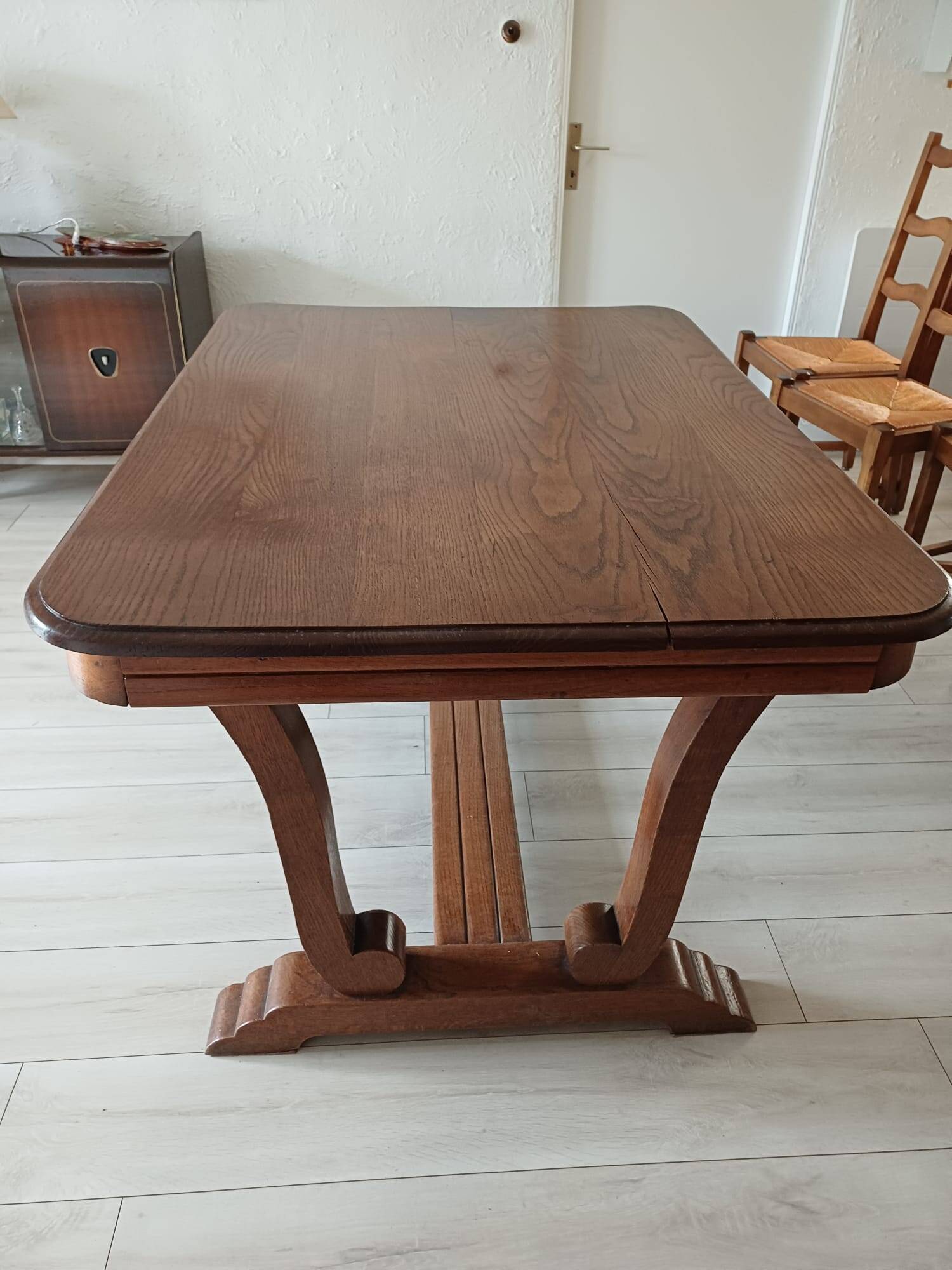 Solid wood dining table with a sculptural base.