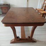 Solid wood dining table with a sculptural base.