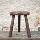 Vintage wooden tripod stool, mountain work, wabi-sabi, shepherd.